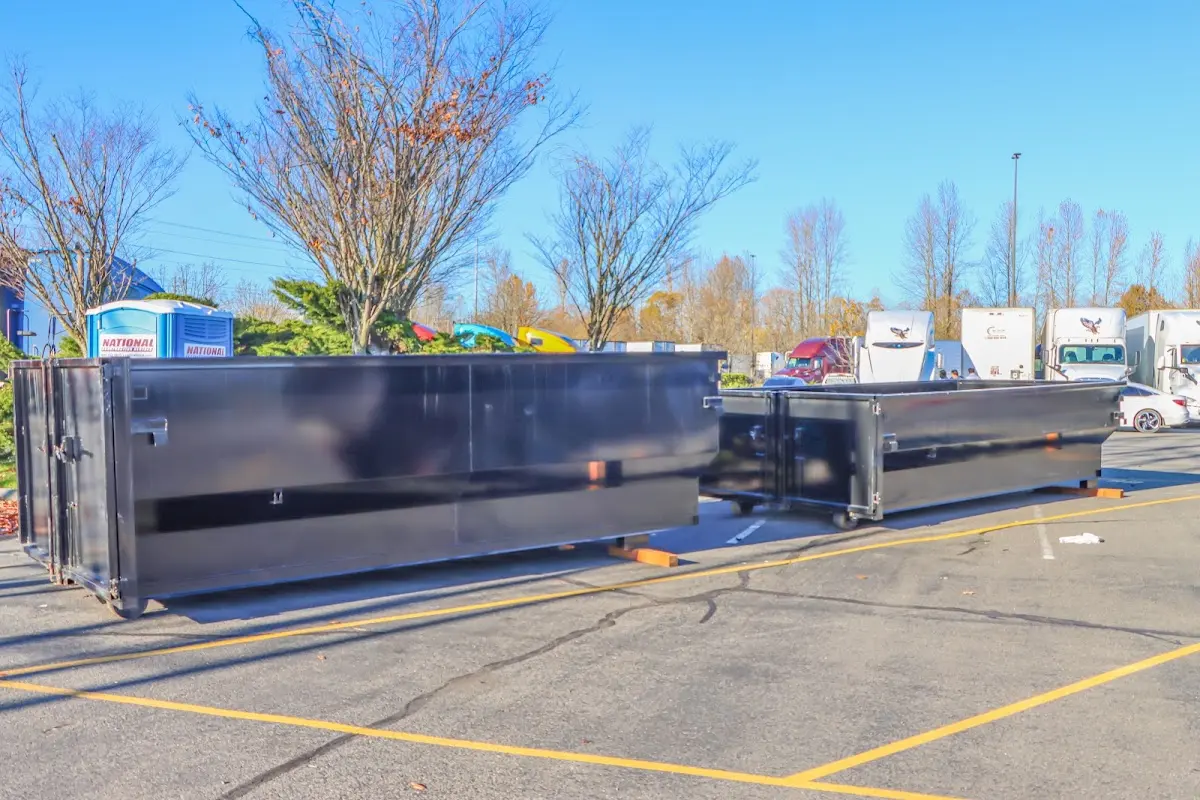 Professional dumpster rental service with roll-off container on residential driveway in Hope Mills